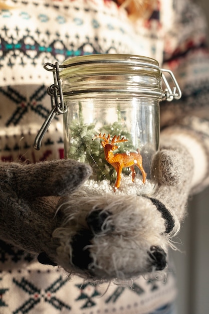 Close-up girl holding jar with deer