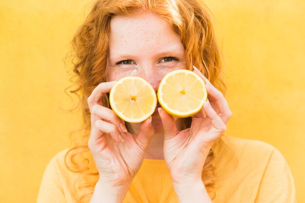 Close-up girl holding lemons
