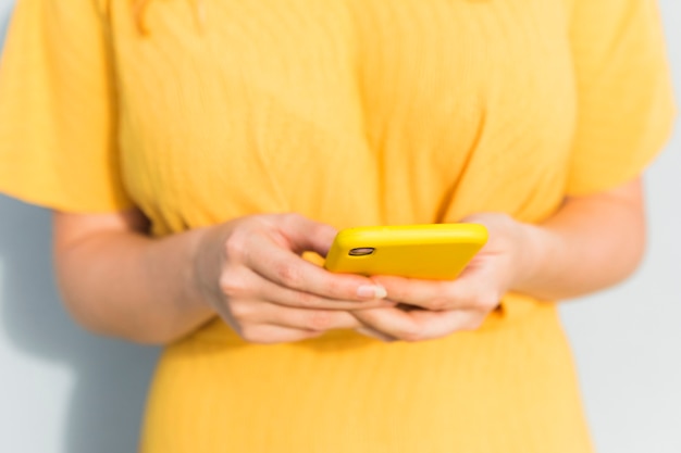Close-up girl holding smartphone