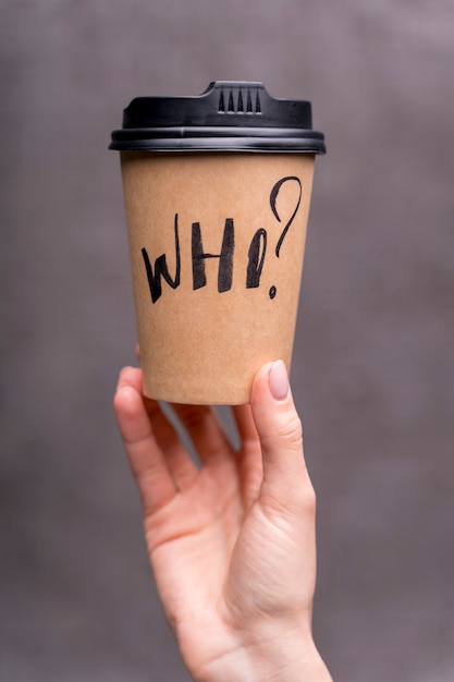 Close-up girl holding up a coffee cup