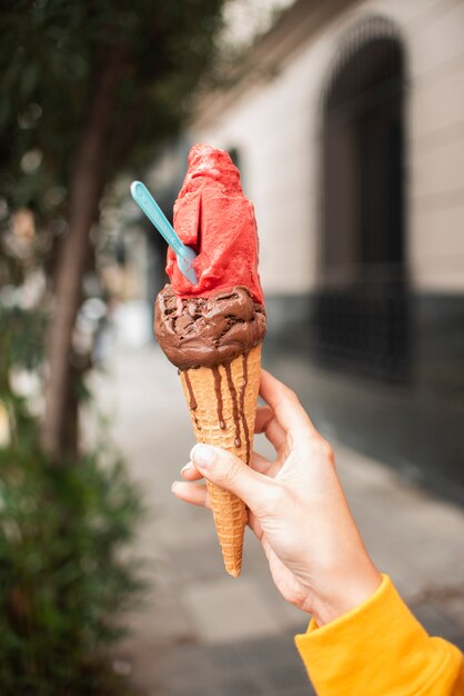 Close-up girl holding up ice cream