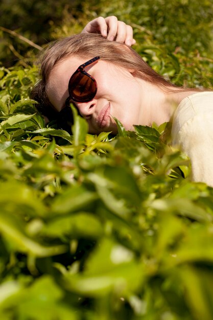 Close-up girl laying on plant