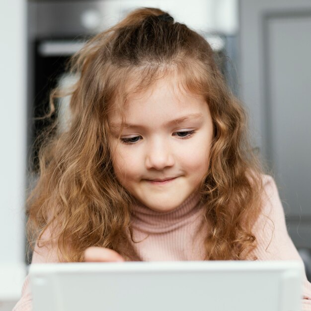 Close-up girl looking at tablet