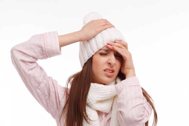 Close-up of girl in pajamas with headache