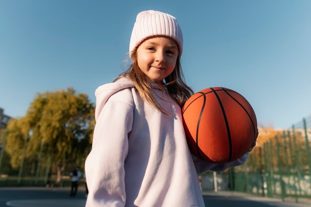 Close up on girl playing basketball