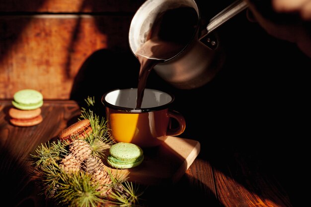 Close-up girl pouring coffee in a mug