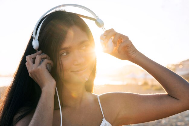 Close-up girl putting on headphones