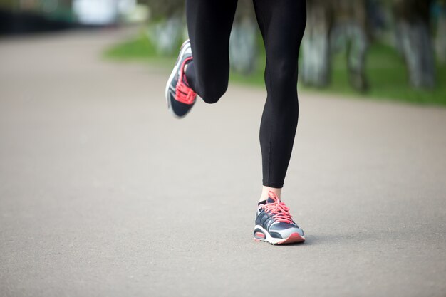 Close-up of girl running with sneakers
