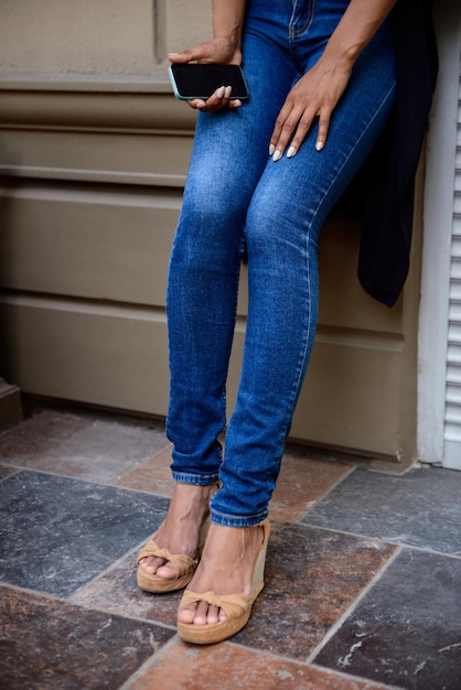 Free photo close up of girl's legs in shoes at street