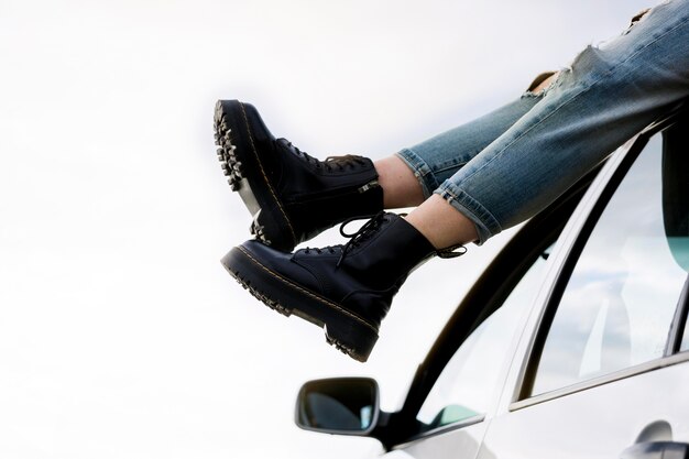 Close-up girl sitting on car