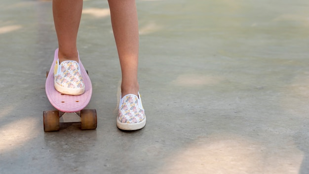 Foto gratuita primo piano della ragazza su skateboard