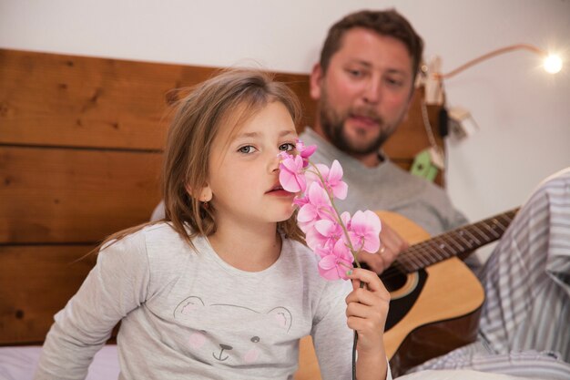 Free photo close-up of girl smelling a flower