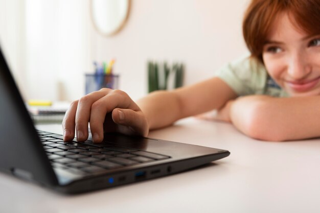 Close up girl studying with laptop