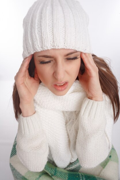  close-up of girl touching her forehead