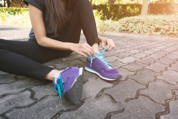 Close-up of girl tying laces