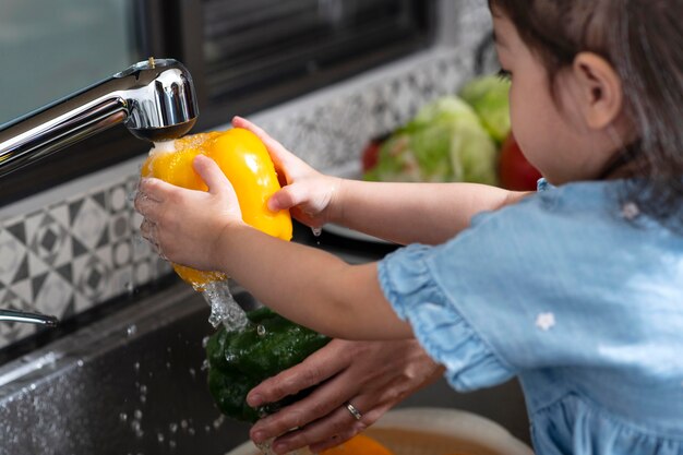 Close up girl washing vegetable