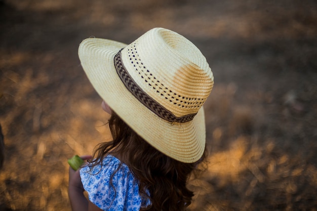 Close-up of a girl wearing straw hat