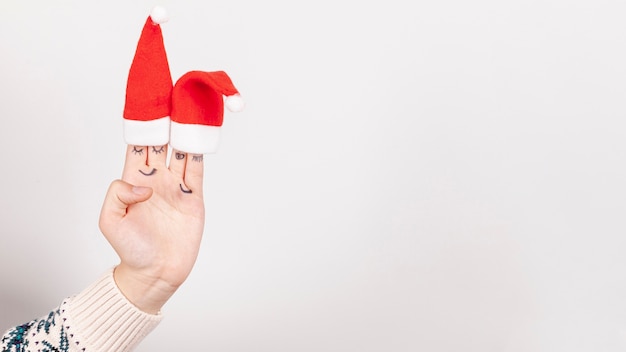 Close-up girl with christmas hats and copy-space