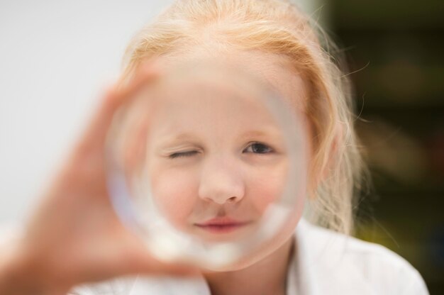 Close-up girl with magnifier