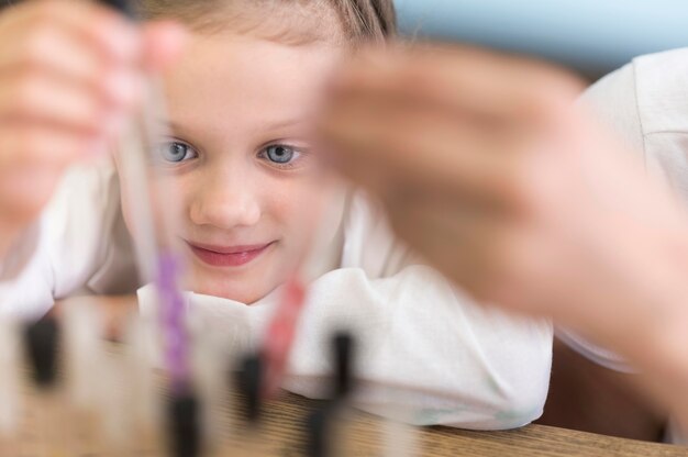 Close-up girl with science tubes