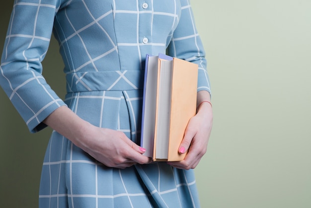 Close-up of girl with two books