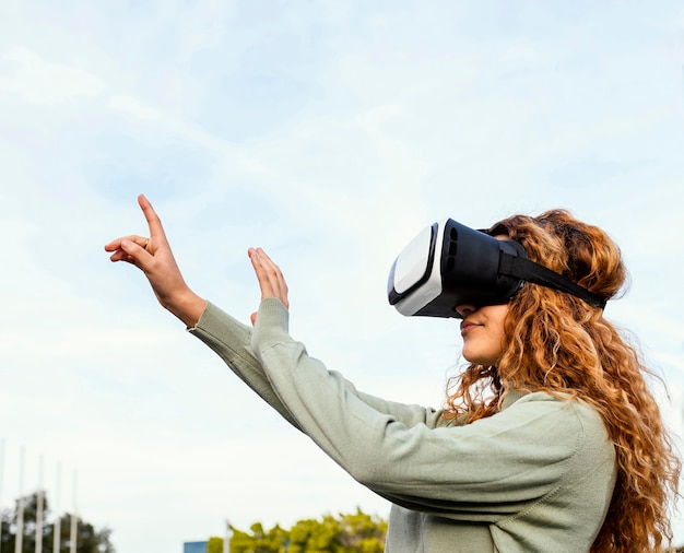 Close-up girl with vr glasses outdoors