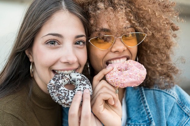 Close-up girls with doughnuts