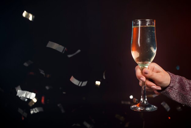 Close-up of glass of champagne with confetti