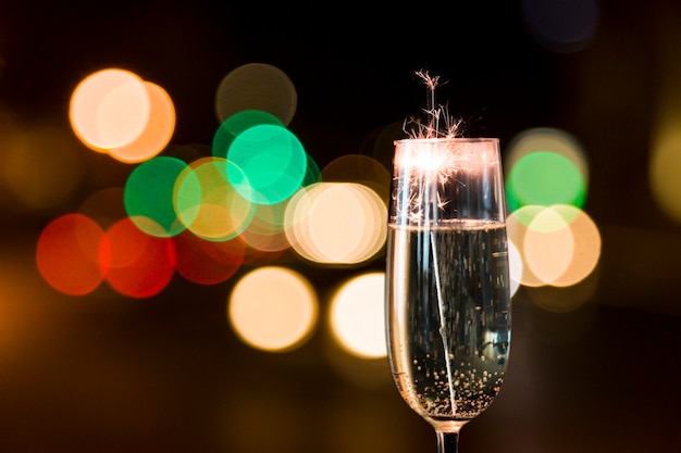 Close-up of glass of champagne with firework