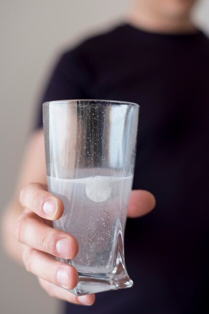 Close-up glass of water and pill