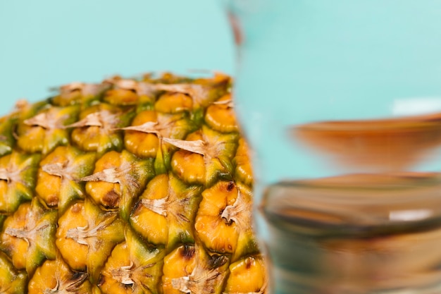 Close-up glass of water and slice of pineapple