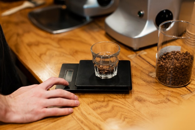 Close-up of glass with coffee beans on scale