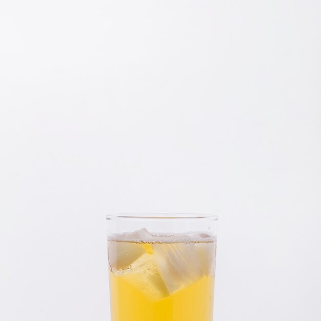 Close-up glass with drink and ice cubes