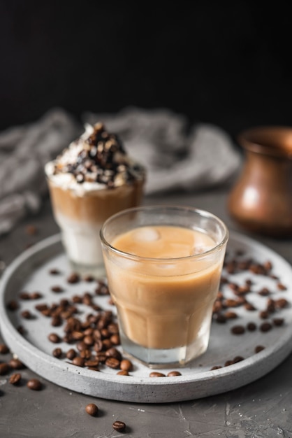 Close-up glass with ice coffee and milk