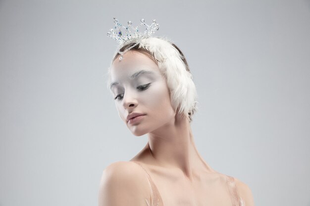 Close up of graceful classic ballerina on white  background.