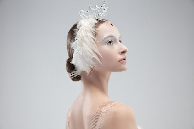 Close up of graceful classic ballerina on white  background.