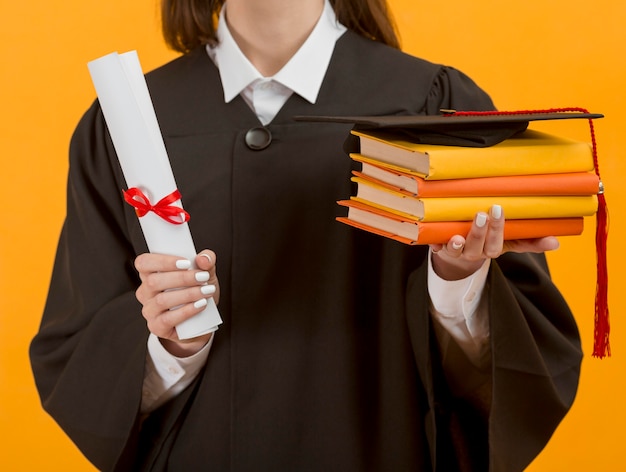 Free photo close up graduate student holding books