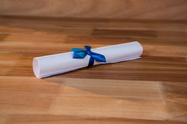 Close-up of graduation certificate on a table