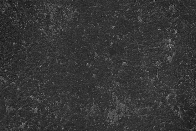 Free photo close up grainy black stucco wall