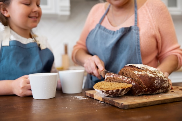 Close up grandma cutting bread