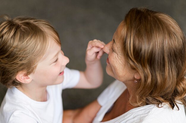 Close-up grandmother and child playing