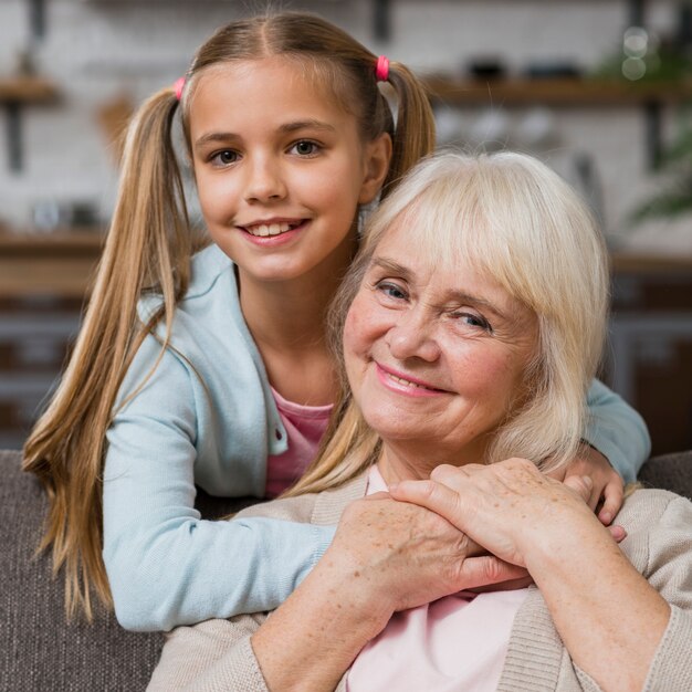 Close-up grandmother and granddaughter smiling