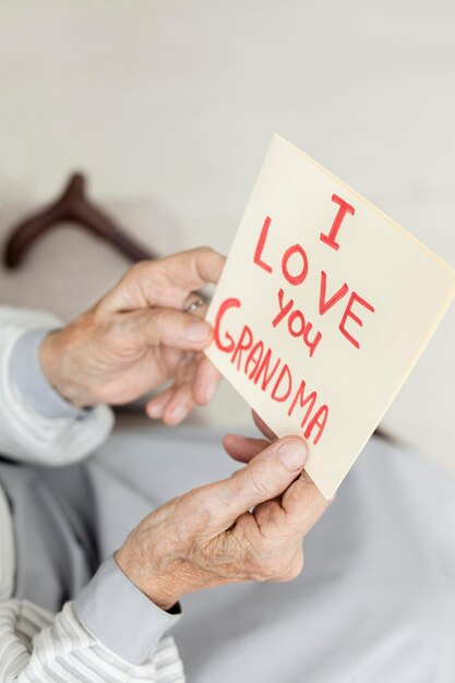 Close-up grandmother holding love message