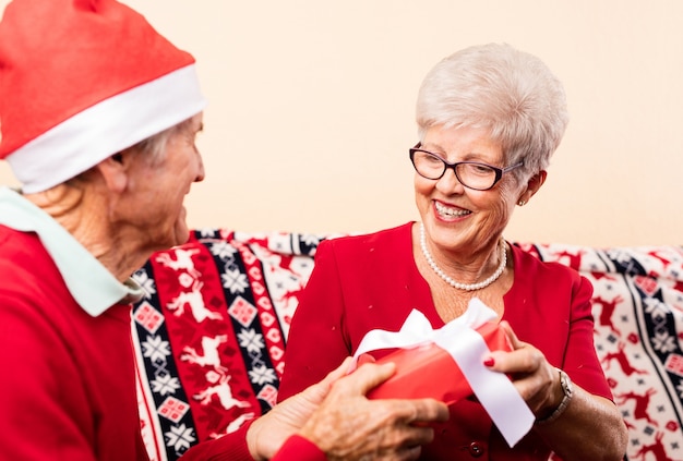 Close-up of grandparents giving christmas presents