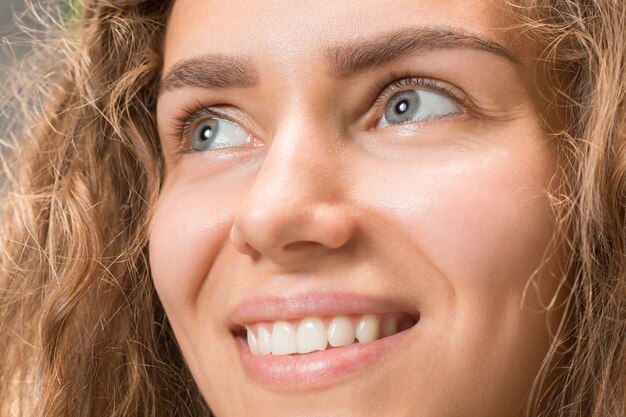 The close up gray eyes on face of young beautiful caucasian girl