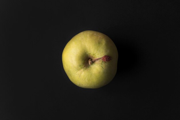 Close up of a green fresh apple isolated over black
