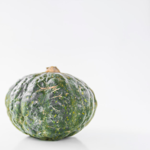 Close-up of a green squash on white background