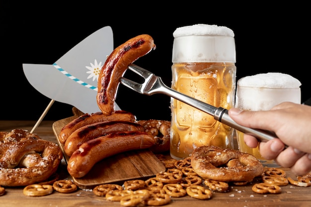 Close-up grill fork with tasty sausage and beer