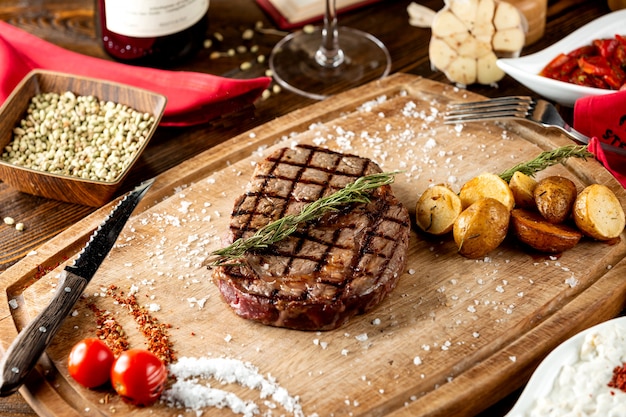 Close up of grilled steak served with roasted potato