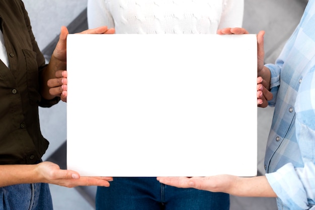 Free photo close-up group of women holding a sign